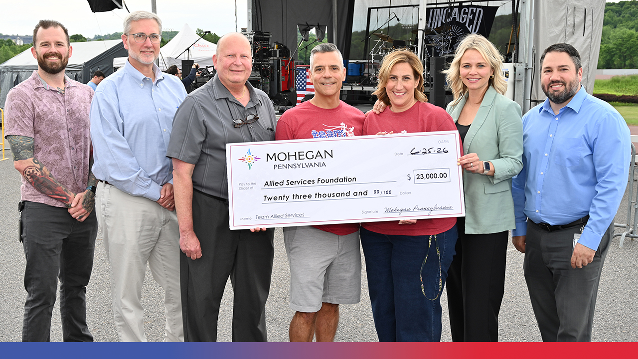 group at Mohegan PA holding large check