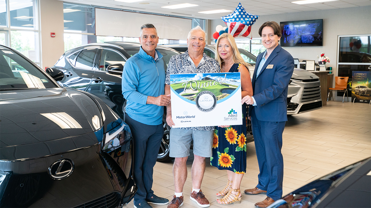 Group standing at lexus dealership