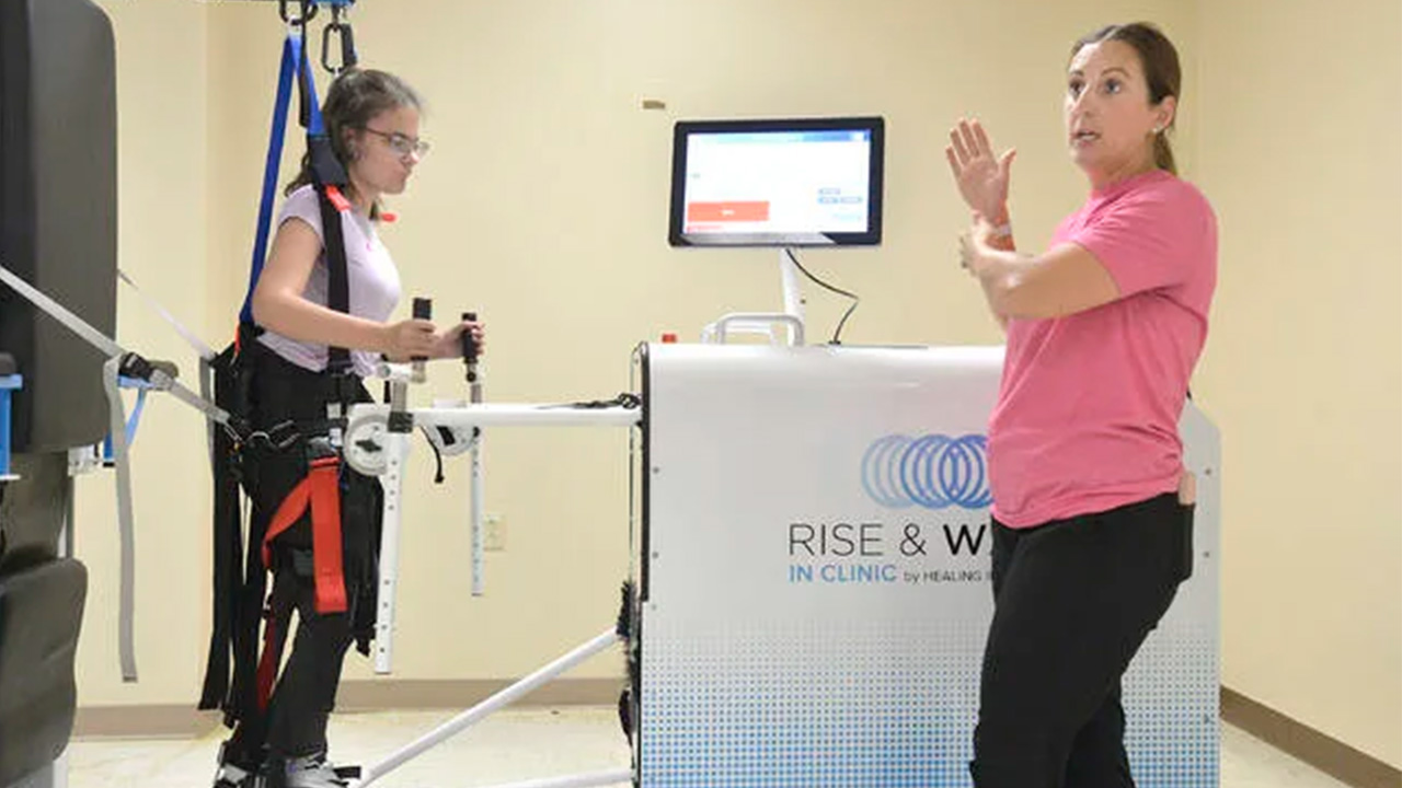 therapist with patient in machine